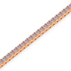 Rose gold bracelet with clear gemstones on a white background