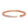 Rose gold bracelet with clear gemstones on a white background