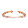 Rose gold bracelet with diamonds on a white background