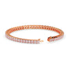 Rose gold bracelet with pink gemstones on a white background