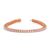 Rose gold bracelet with clear gemstones on a white background