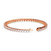 Rose gold bracelet with heart and diamond designs on a white background