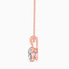 Rose gold necklace with a clear gemstone on a white background