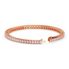 Rose gold bracelet with clear gemstones on a white background