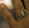 Close-up of a hand wearing a decorative ring with 'cheriva jewels' branding.