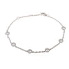 Silver bracelet with round gemstones on a white background