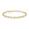 Gold bracelet with clear stones on a white background