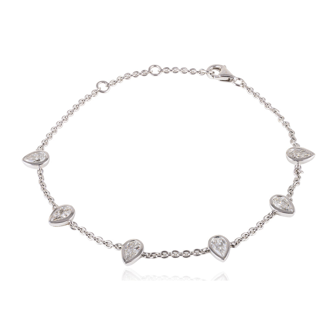 Silver bracelet with heart-shaped diamond a white background
