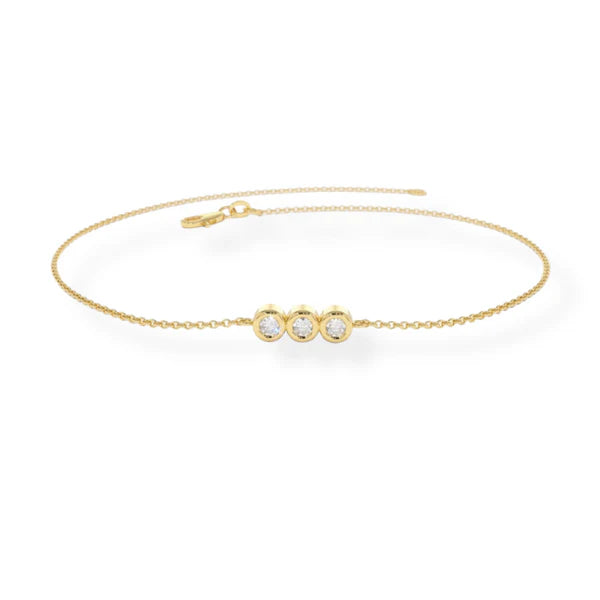 Gold bracelet with three pearl-like stones on a white background