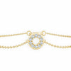 Gold bracelet with a circular diamond pendant on a white background