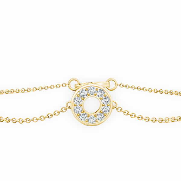 Gold bracelet with a circular diamond pendant on a white background