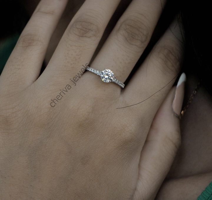 Diamond ring on a hand with 'cheriva jewels' branding.