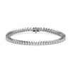 Tennis bracelet featuring 4 carats of pear cut diamonds in a continuous line design on a white background