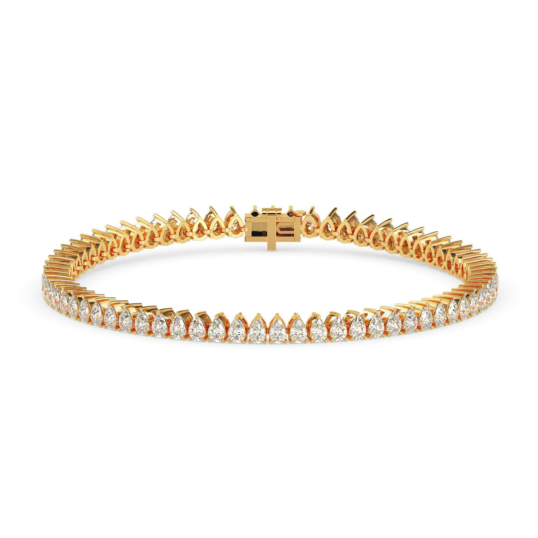Gold tennis bracelet with 4 carats of pear cut diamonds in a sleek, elegant line design on white backgrund