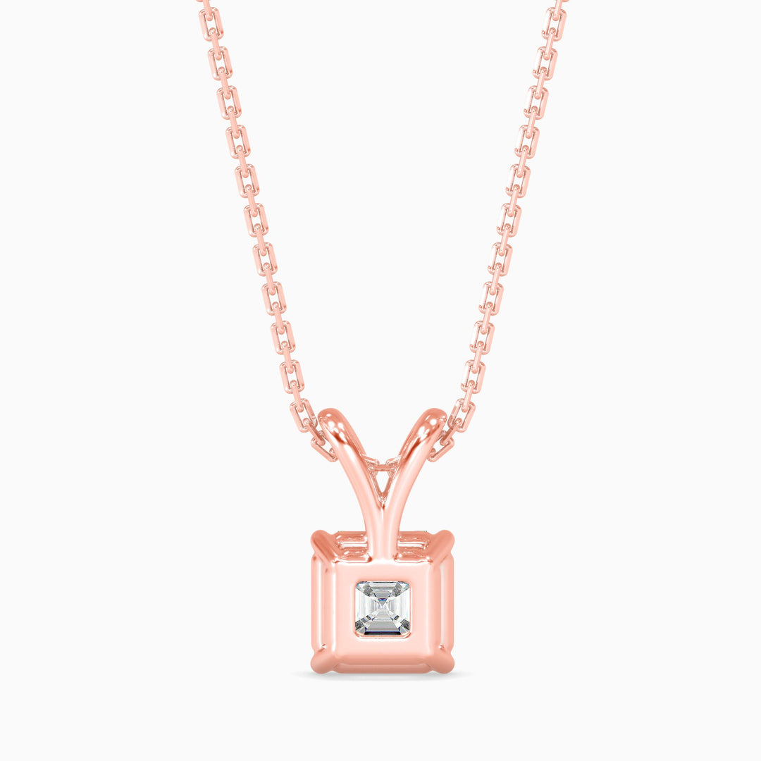 Rose gold necklace with a square-cut diamond pendant on a white background