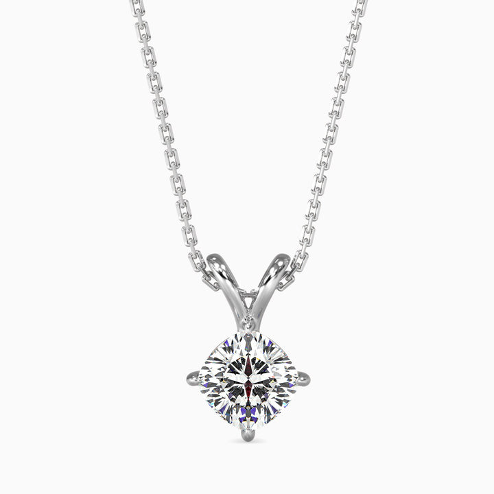 A cushion cut diamond pendant with a colorless stone set in a white gold or silver setting, suspended from a chain.