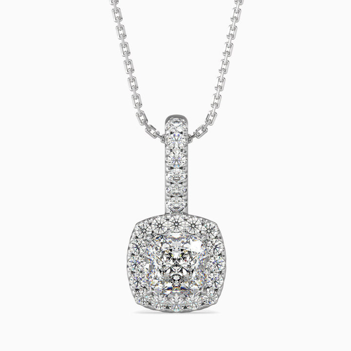 A cushion cut halo pendant with a diamond encrusted chain and pendant setting, showcasing a single central diamond.