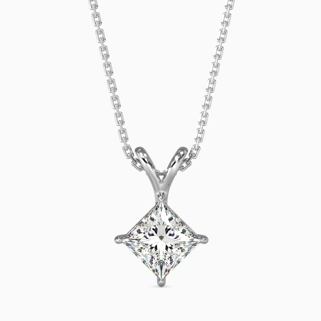 A princess cut diamond pendant with a colorless stone set in a white gold chain.