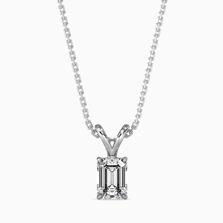 An emerald cut diamond pendant with a colorless stone set in a white gold chain.