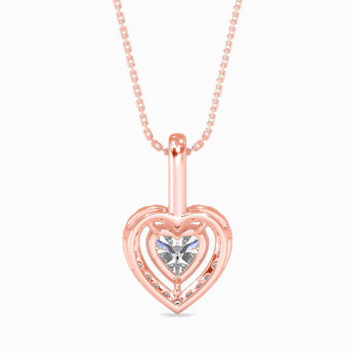 Rose gold heart-shaped pendant necklace with a clear gemstone on a white background