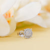 Silver earring with clear gemstones on a soft, blurred background