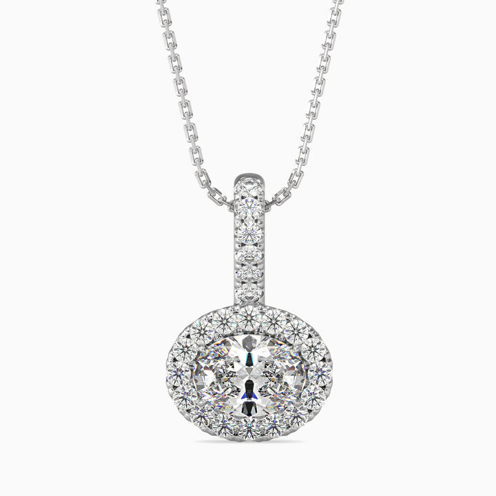 An oval cut halo pendant with a diamond encrusted setting on a white background.