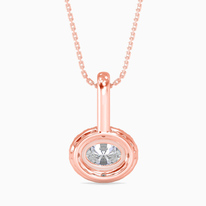 Rose gold pendant with a clear gemstone on a white background