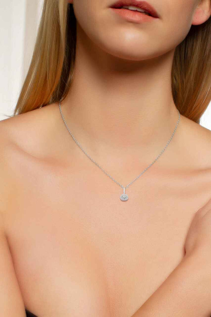 Oval cut silver halo pendant wearing by a model