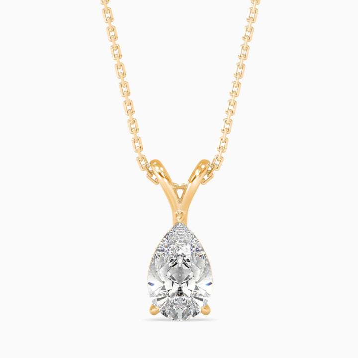 Gold necklace with a teardrop-shaped diamond pendant on a white background