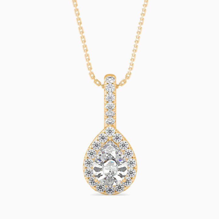 Gold and diamond teardrop pendant on a white background