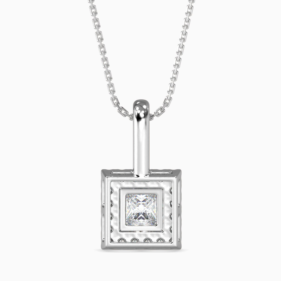 Silver pendant with a diamond on a white background