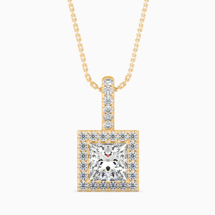 Gold necklace with a square diamond pendant on a white background