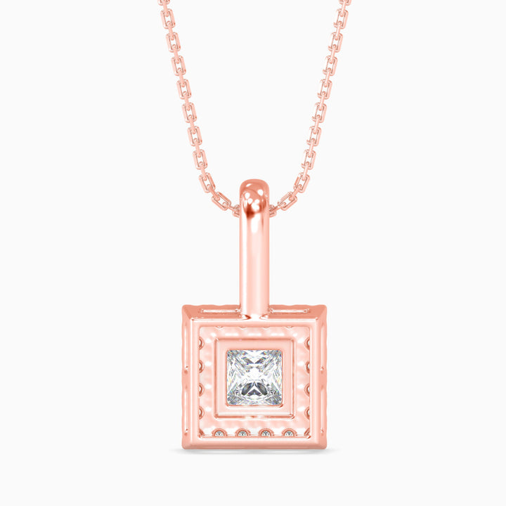 Rose gold pendant with a diamond on a white background