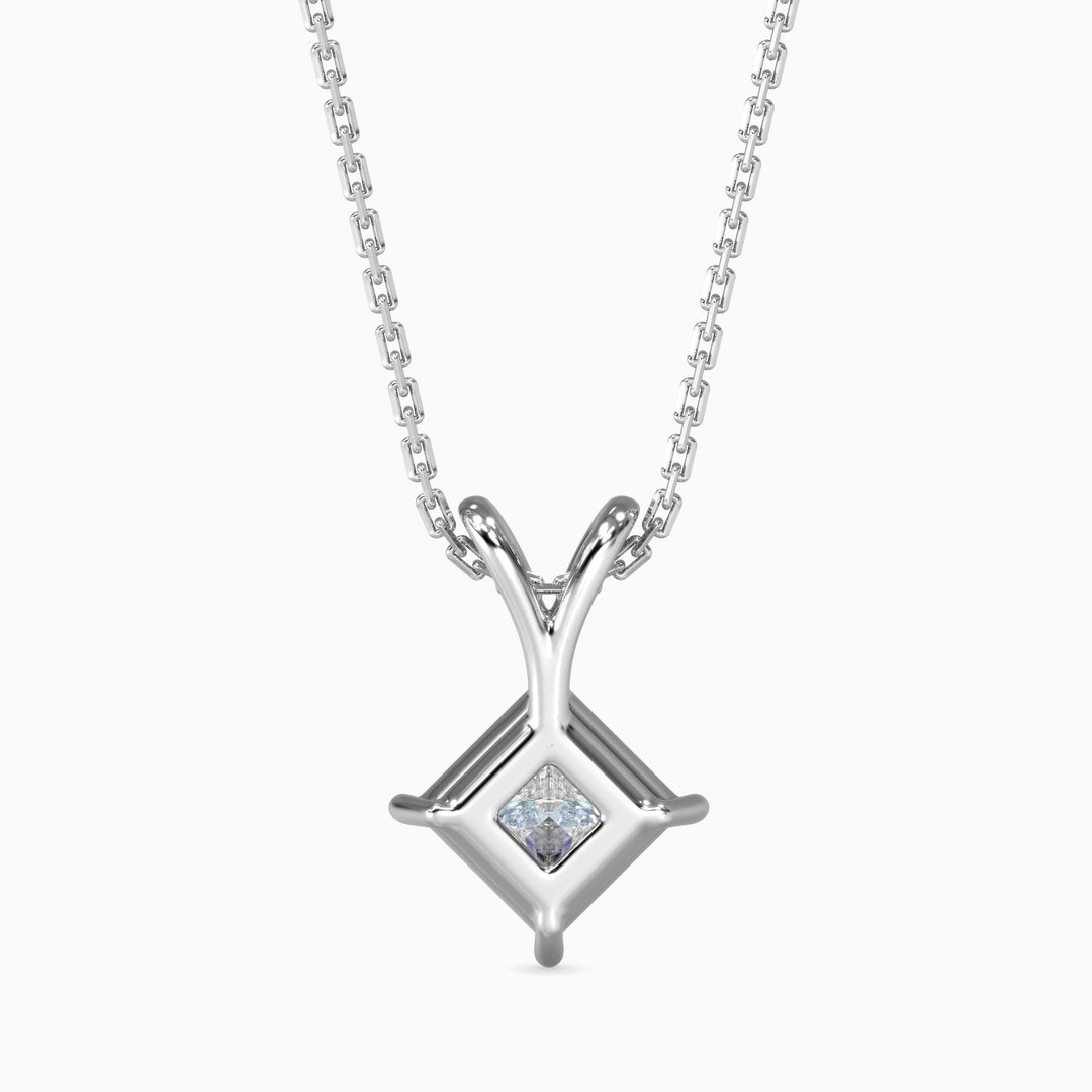 Silver necklace with a square pendant featuring a diamond on a white background