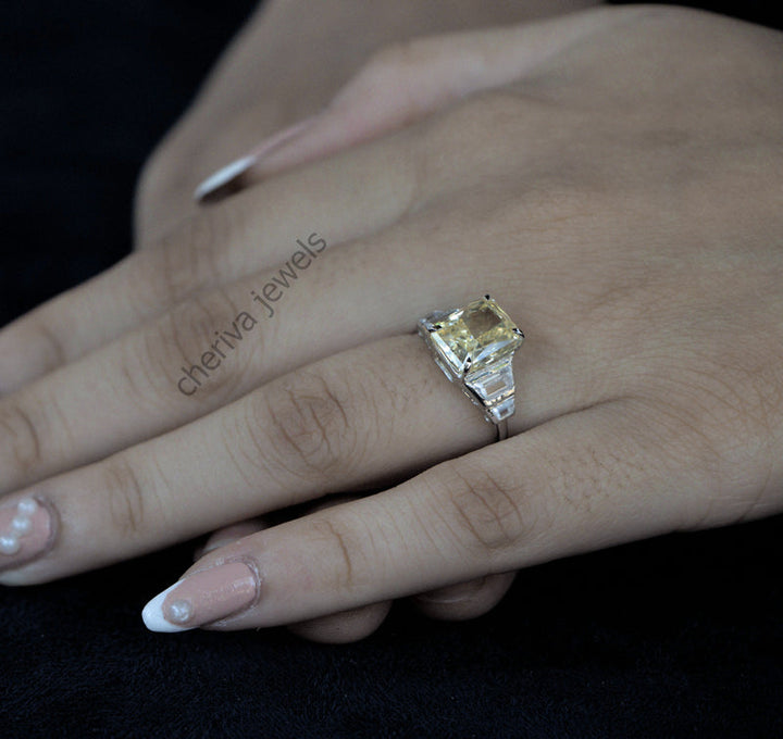 Hand wearing a yellow gemstone ring with 'cheriva jewels' branding.