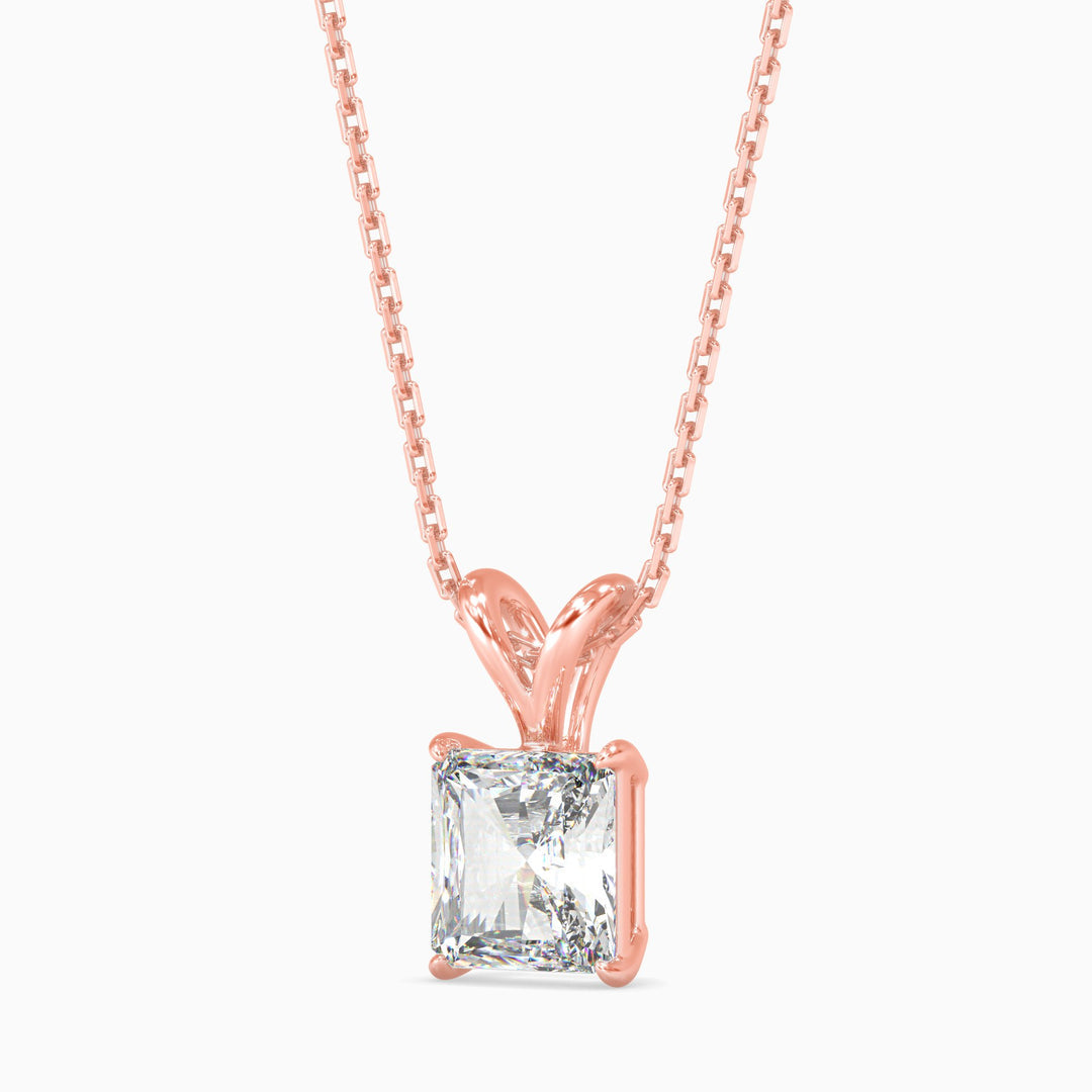 Rose gold necklace with a clear gemstone on a white background