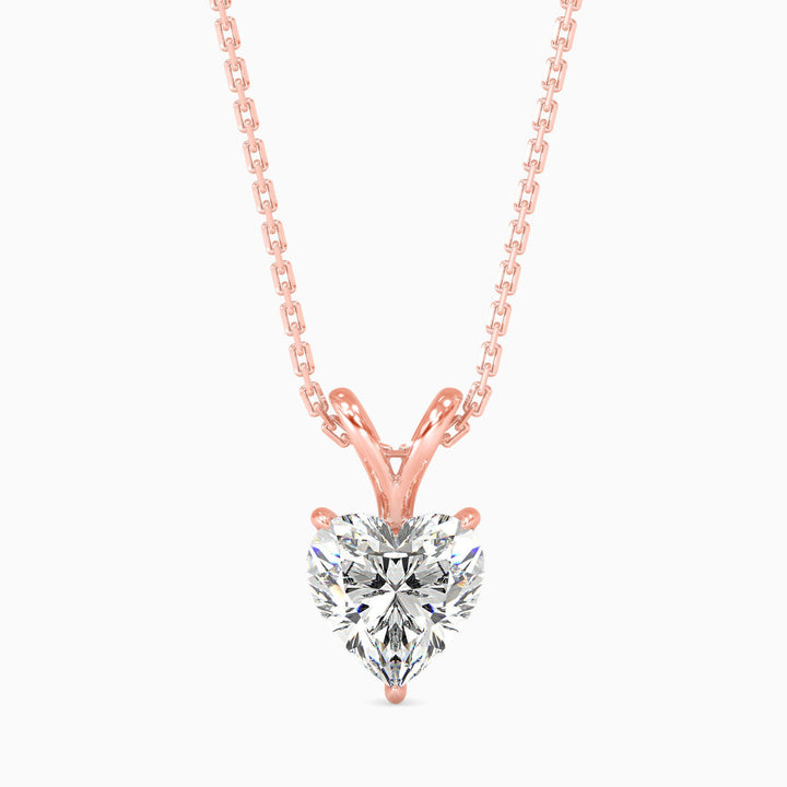 Rose gold necklace with a heart-shaped diamond pendant on a white background