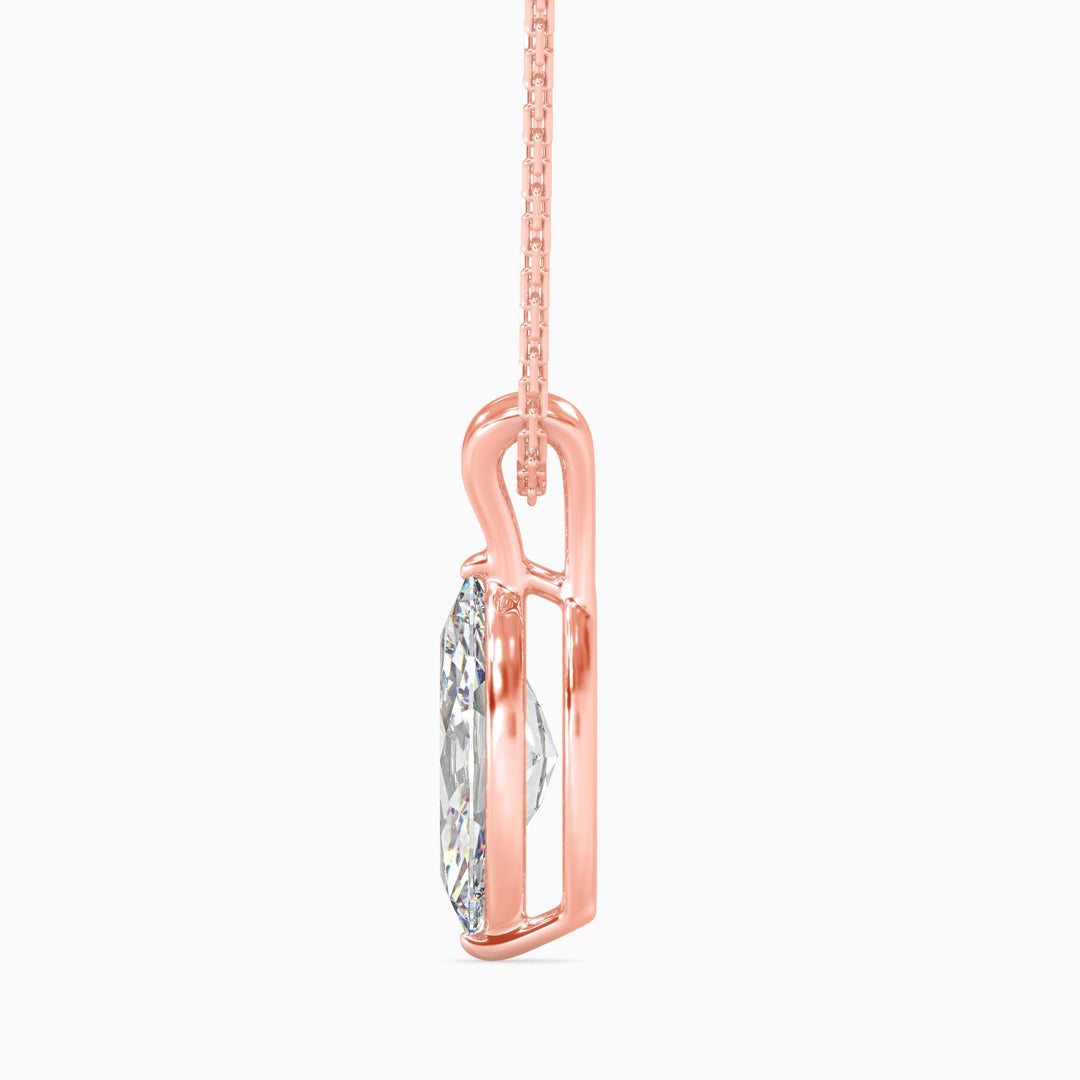 Rose gold pendant with a diamond on a white background