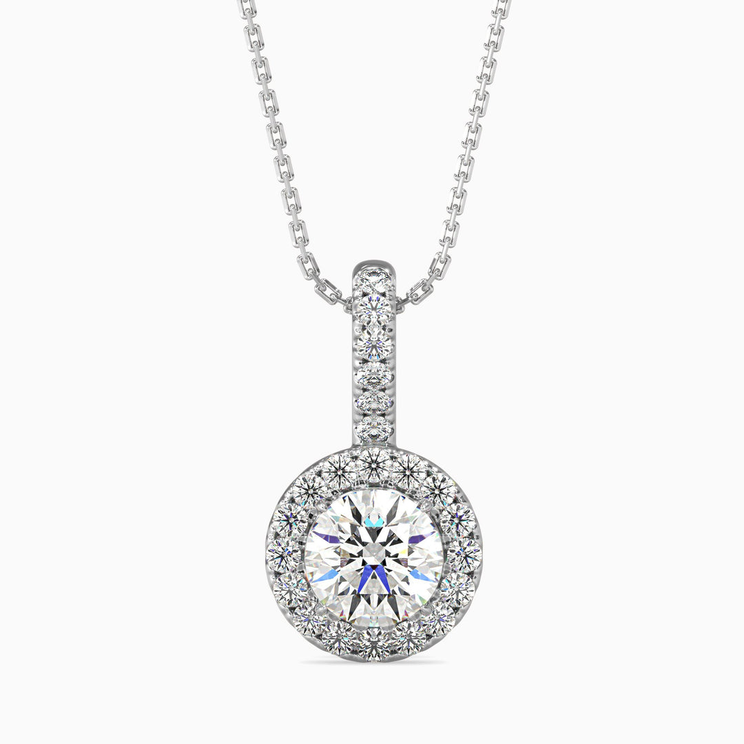 A round halo pendant with a central diamond surrounded by smaller diamonds, set in a white gold or silver chain.