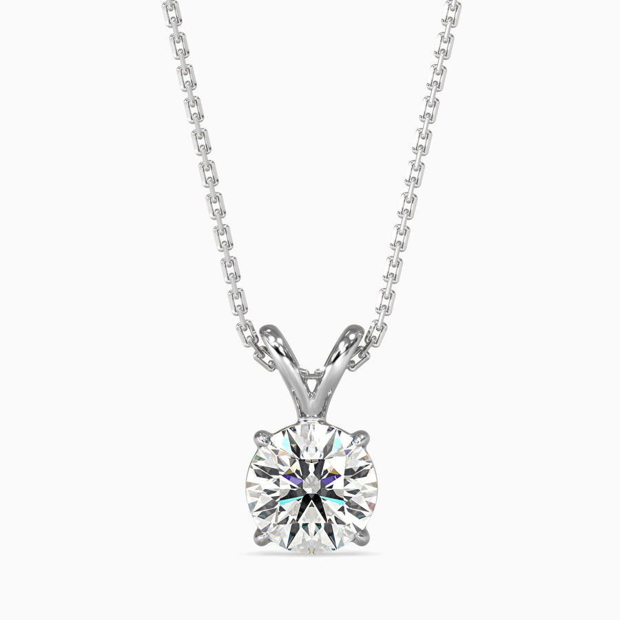 A round cut diamond pendant with a chain, set against a white background.