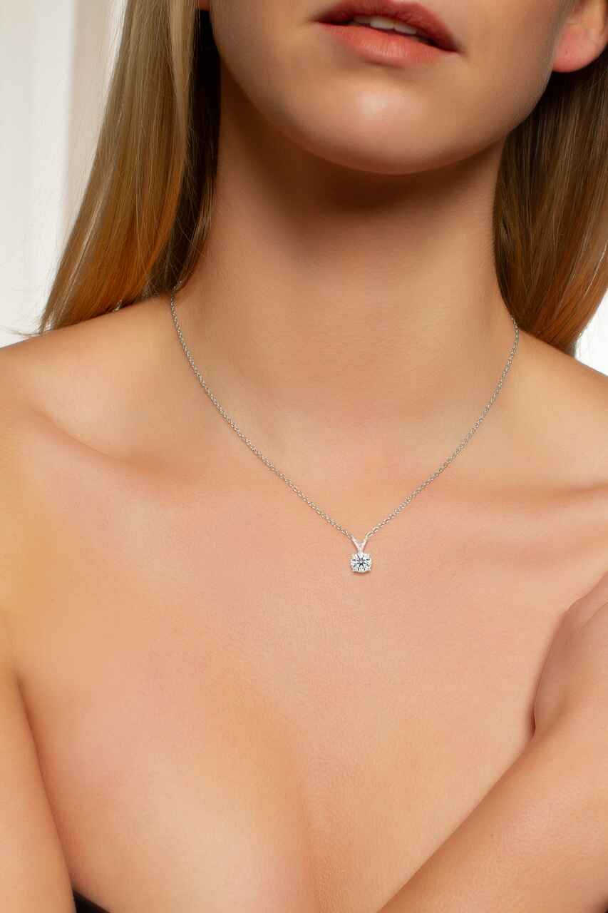 Necklace with a pendant worn by a model against a neutral background