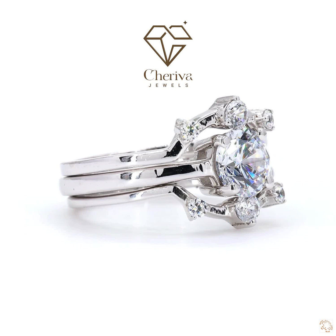 Silver ring with a large diamond and smaller diamonds on a white background, featuring Cheriva Jewels logo.