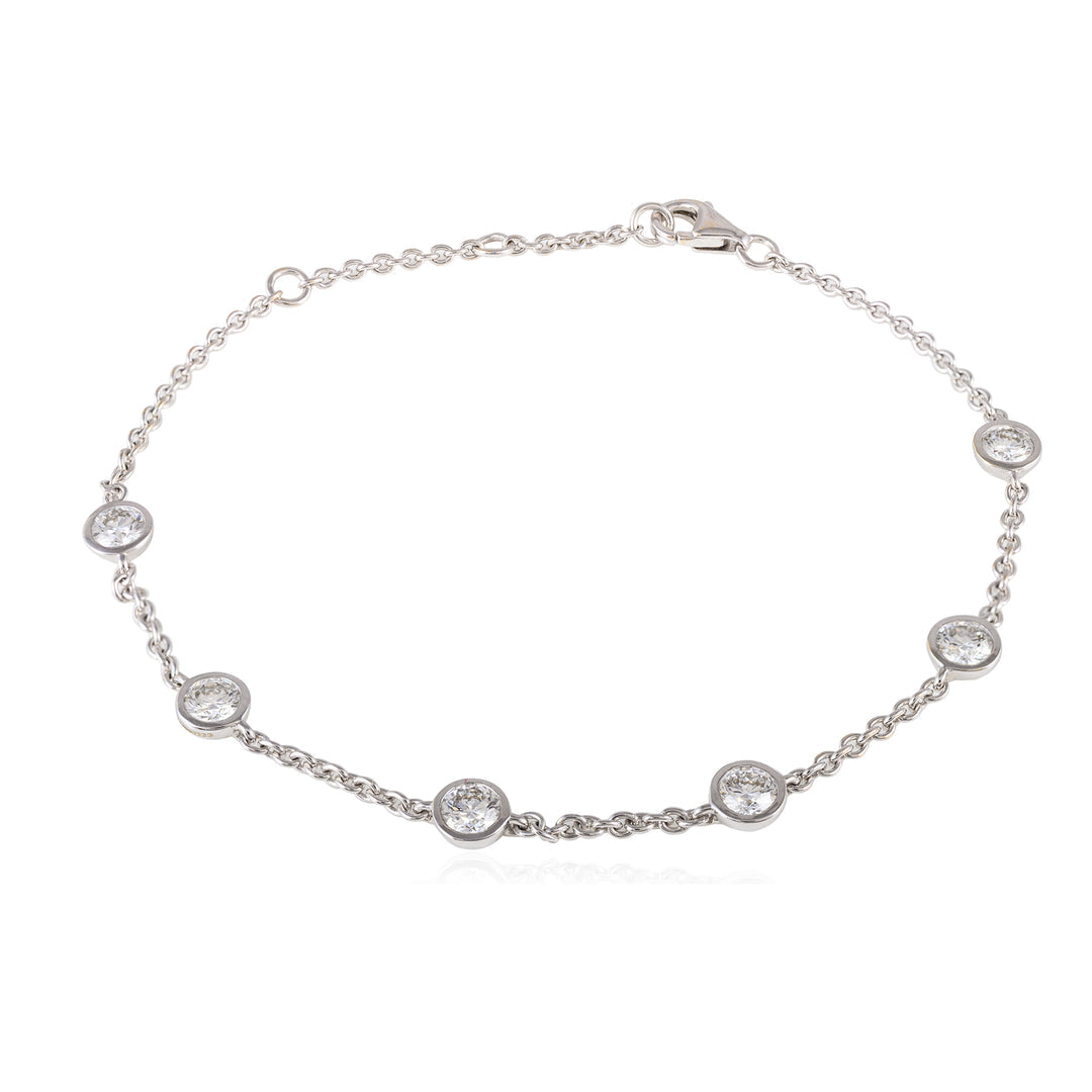 Silver bracelet with round gemstones on a white background
