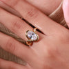 oval cut diamond with round cut sidestone.