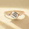 emerald cut diamond engagement ring with round cut sidestone.