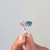 blue round diamond in round diamond ring.