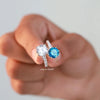 round cut diamond ring beside round diamond ring.