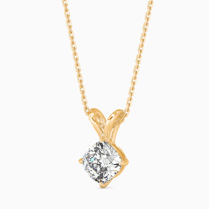 Gold necklace with a diamond pendant on a white background
