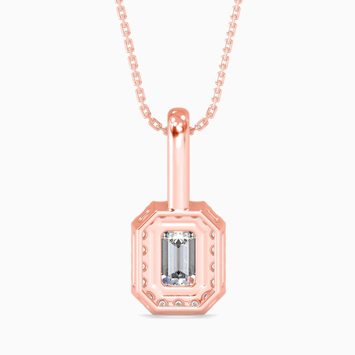 Rose gold pendant necklace with a clear gemstone on a white background