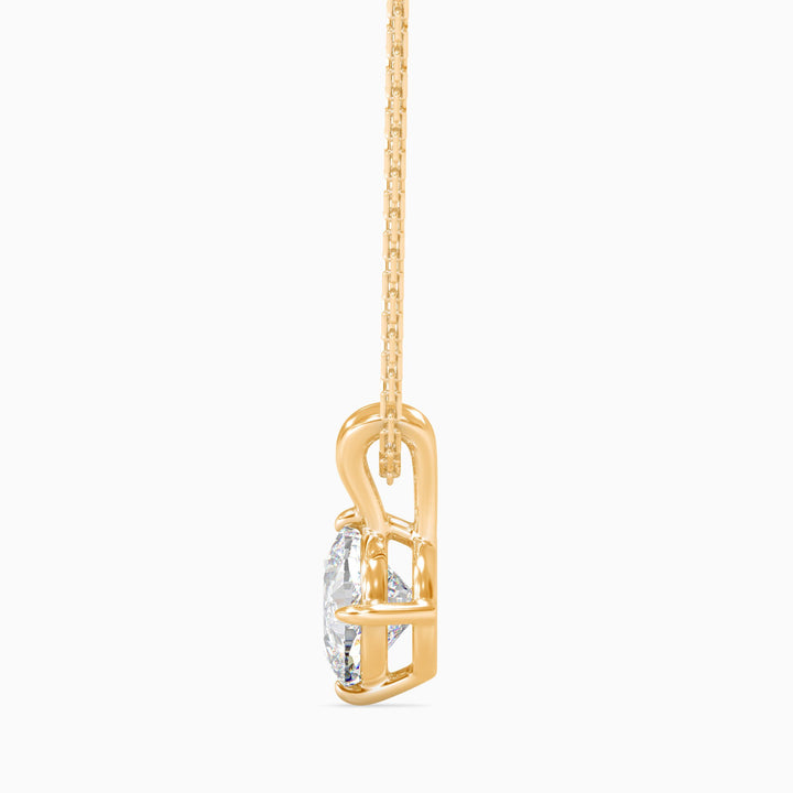 Gold necklace with a clear crystal pendant on a white background